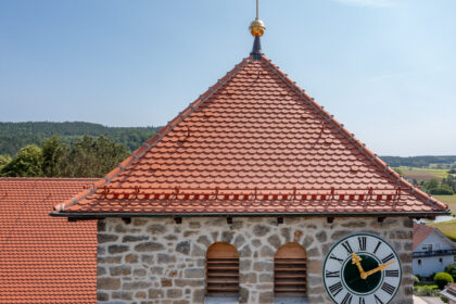Verstärkter süddeutscher Biber Rundschnitt auf Pfarrkirche in Waffenbrunn im Bild der Biberfirst konisch und Lüfterziegel.