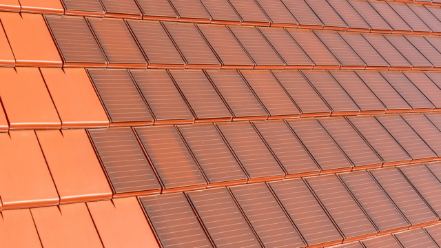 Surface covered with Stylist-PV solar roof tiles in red-brown