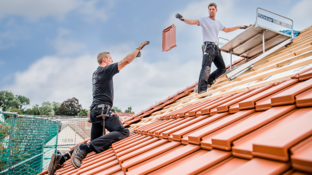 Roofer covering a roof