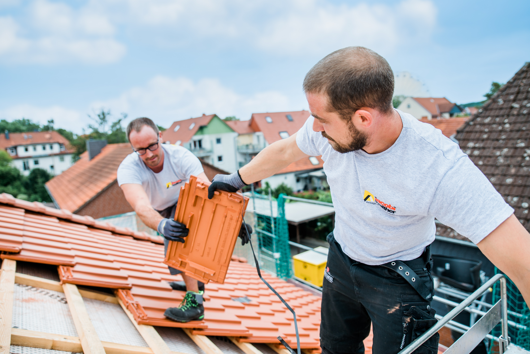 Roofer covering clay roof tiles on the roof