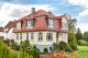 Einfamilienhaus mit Mansarddach, gedeckt mit Biberschwanzziegel in rotbraun