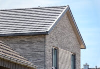 Inspiringly beautiful clinker brick house with flat bricks in noble slate laid in a row with picture focus on the gable