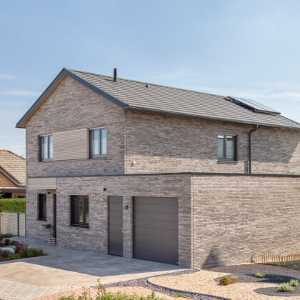 Inspiring, beautiful clinker brick house with flat tiles laid in rows in noble slate