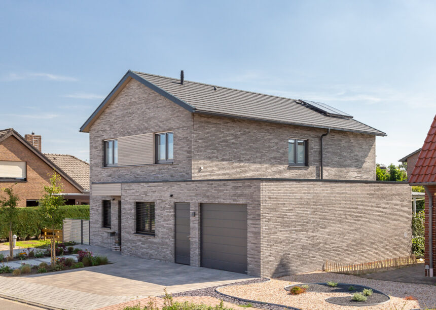 Inspiring, beautiful clinker brick house with flat tiles laid in rows in noble slate