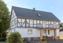 Half-timbered house with modern noble slate flat tile