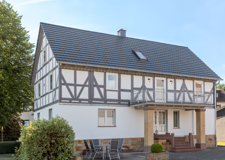 Half-timbered house with modern noble slate flat tile