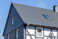 Half-timbered house with modern noble slate flat tile