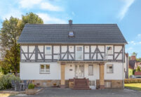 Half-timbered house with modern noble slate flat tile