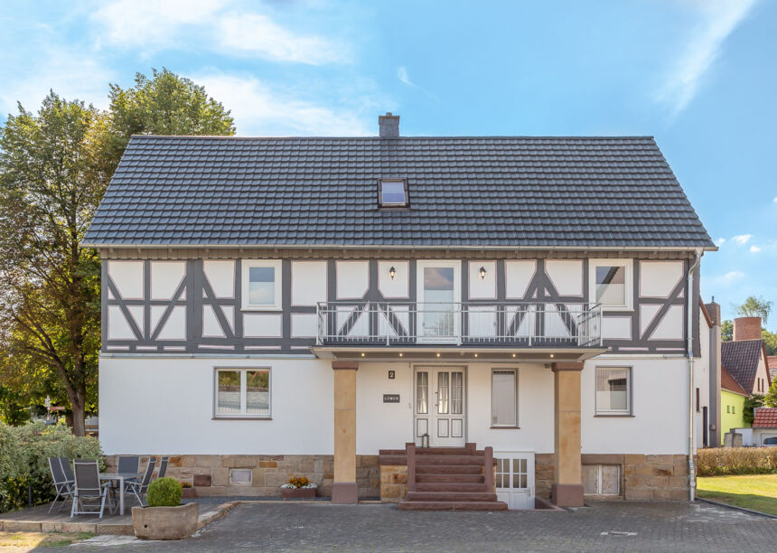 Half-timbered house with modern noble slate flat tile