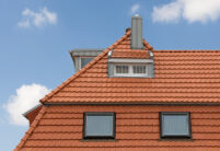 Refurbished detached house with mansard roof in natural red