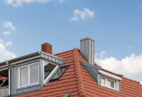 Refurbished detached house with mansard roof in natural red