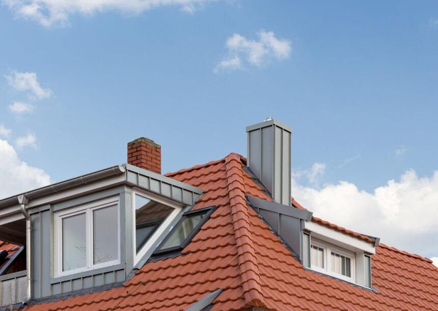 Refurbished detached house with mansard roof in natural red