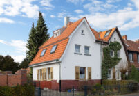 Refurbished detached house with mansard roof in natural red