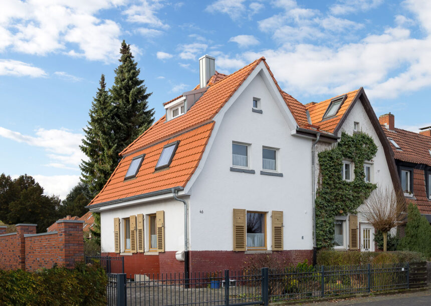 Refurbished detached house with mansard roof in natural red