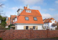 Refurbished detached house with mansard roof in natural red